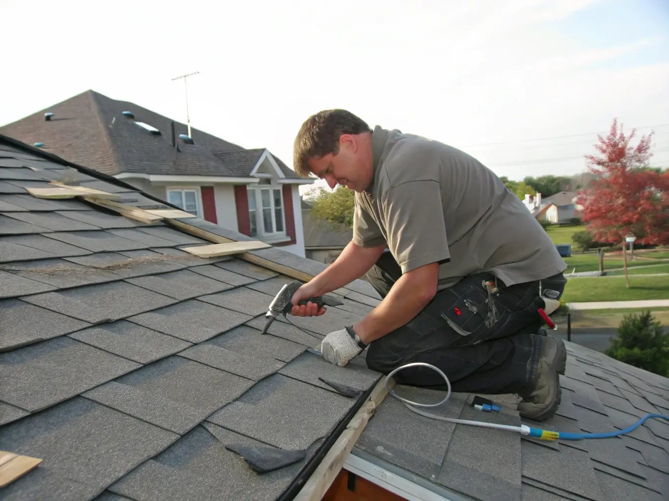 A close-up shot of a roofing technician repairing a damaged roof, focusing on the tools and techniques used to fix the issue. The image should convey expertise and attention to detail.
